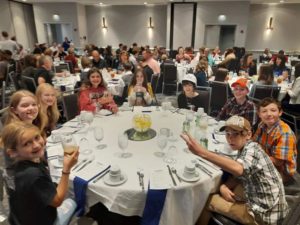 The group eating dinner at awards ceremony